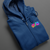 Premium deep blue zip up hoodie featuring the PulseChain, Hex, and PulseX trinity logo, displayed on a grey background.